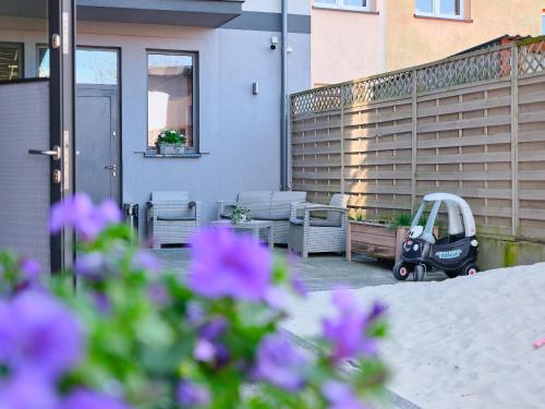 a scooter parked on the patio of a house at Villa Łeba Pokoje & Apartamenty in Łeba