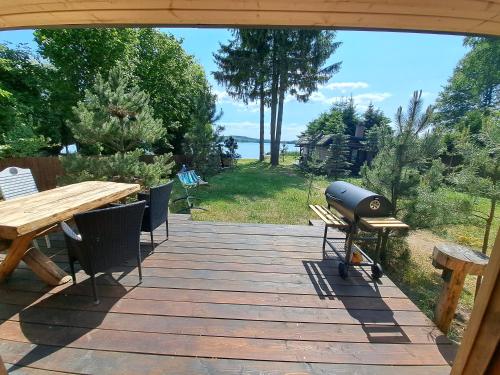 a patio with a grill and a picnic table at Siedlisko nad Jeziorem-Mazury in Mrągowo