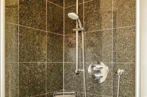 a shower with a shower head in a bathroom at Hus Wittdün Deck 1 Baltrum in Baltrum