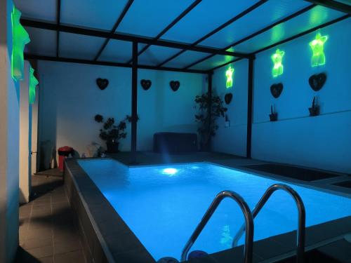 a swimming pool in a house with blue lights at Pinar Suites Loft in Torremolinos