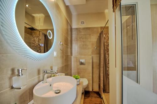 a bathroom with a sink and a mirror at Beach Villa Christina by PosarelliVillas in Acharavi