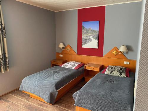una camera con due letti e un dipinto rosso di Hotel zum Ziehbrunnen a Berlino