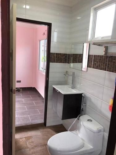a bathroom with a toilet and a sink at Ceria Homestay Putatan in Putatan