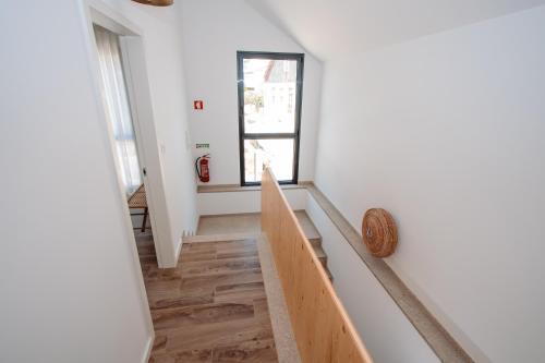 a room with a staircase and a window at Chalês - Maria Alva in Marialva