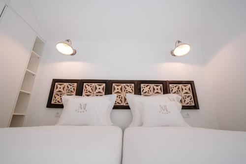 two white pillows on a bed in a room at Chalês - Maria Alva in Marialva