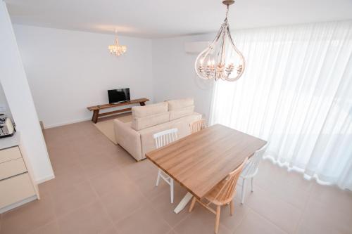a living room with a table and a couch at Chalês - Maria Alva in Marialva