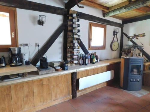 a kitchen with a counter and a stove in a room at Chaleureuse Maison de pays Serre Chevalier4étoiles in Le Monêtier-les-Bains