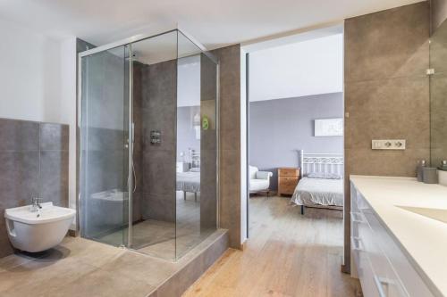 a bathroom with a shower and a toilet and a sink at HHBCN Beach apartment Gava #1 in Gavà