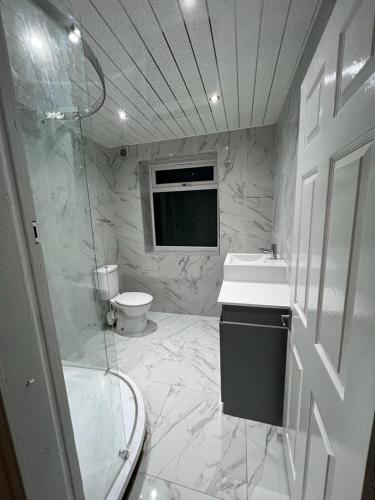 a bathroom with a shower and a sink and a toilet at The Pleasant House in Manchester