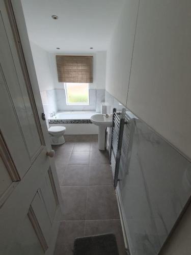 a small bathroom with a toilet and a sink at 2 bedroom house - Hopefield Road in Leicester