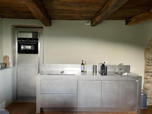 a kitchen with a sink and a counter top at Cascina Manzoni appartamenti in Bossolasco