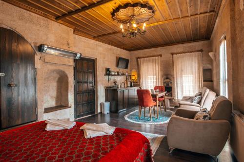 a bedroom with a bed and a living room at Adelya Cave Hotel Apartments in Göreme