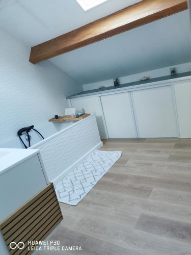 a room with white cabinets and a bench in it at 2 chambres privatives avec Sdb proche circuit in Arnage