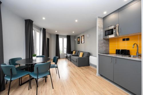 a kitchen and living room with a table and chairs at Staycity Aparthotels Paris Gare de l'Est in Paris