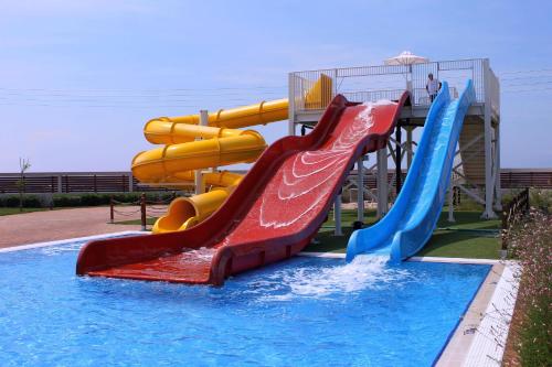 a water park with a water slide in a pool at Almyros Beach in Acharavi