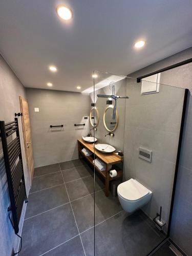 a bathroom with a toilet and a sink and a shower at The Vila Bled Premium Luxury Retreat in Bled