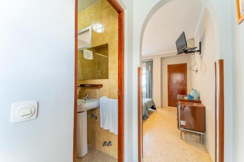 a bathroom with a sink and a mirror at Hostal Miramar in Los Caños de Meca