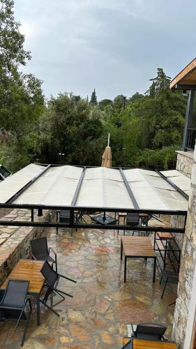 a pavilion with tables and chairs on a patio at 7011 Dadya Rooms in Datca