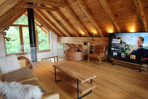 a living room with a large flat screen tv at The Vila Bled Premium Luxury Retreat in Bled