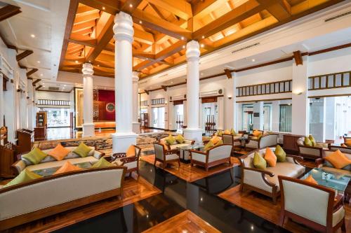 a lobby of a resort with couches and chairs at Tawa Ravadee Resort Prachinburi, a member of WorldHotels Distinctive in Si Maha Phot