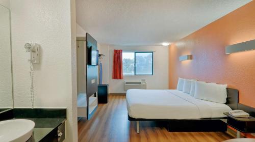 a hotel room with a bed and a bathroom at Suites Los Angeles CA Los Angeles LAX in Inglewood