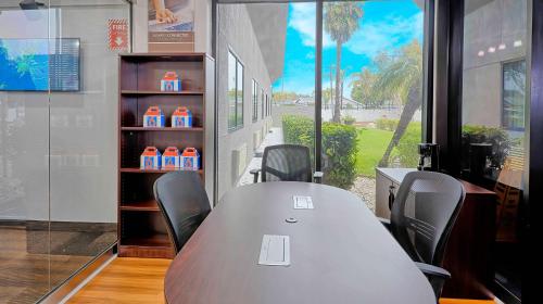 a conference room with a table and chairs and a window at Suites Los Angeles CA Los Angeles LAX in Inglewood