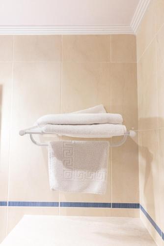 a stack of towels on a shelf in a bathroom at Legaire Etxea in Ibarguren
