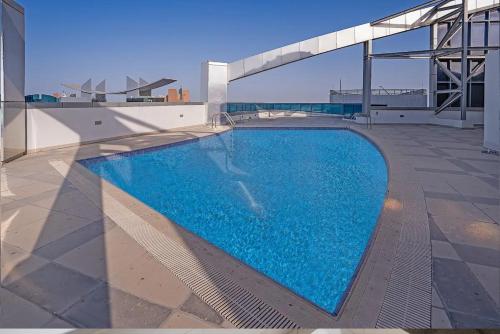 a swimming pool on the roof of a building at SPACIOUS 3 Bedroom Apartment (Sea View) in Abu Dhabi