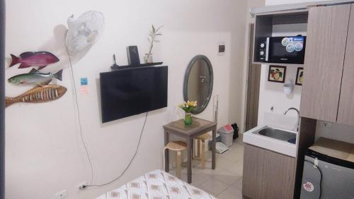 a small room with a television and a bathroom at JJMC HOMESTAY 22 With netflix and fast wifi in Manila