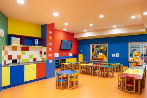 a kindergarten classroom with colorful walls and tables and chairs at Golden Bahía de Tossa & Spa 4* Sup. in Tossa de Mar