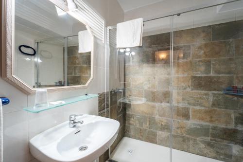 a bathroom with a sink and a shower at Hostal Miramar in Los Caños de Meca