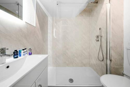 a white bathroom with a shower and a toilet at ✪ 2-Bed Ground Floor Flat ✪Chelmsford✪ Prime Location in Chelmsford