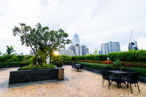a patio with tables and chairs and a city skyline at Lohas Residences Sukhumvit 2 in Bangkok