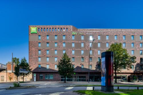 a large brick building in front of a street at ibis Styles Hamburg Barmbek in Hamburg