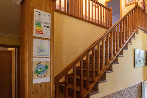 a staircase in a building with a wooden railing at Legaire Etxea in Ibarguren