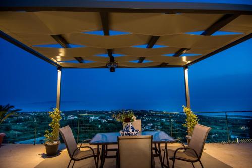 a table and chairs on a balcony with a view at Eftychia's Home in Svoronata