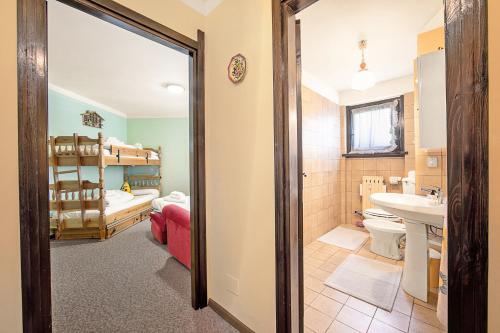 a bathroom with a sink and a toilet and a tub at Appartamento Pian dei Larici - Happy Rentals in Sauze d'Oulx