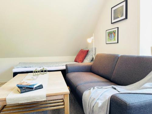 a living room with a couch and a bed at Scandinavian Apartment Hotel - Prison Museum 2 - one room apartment in Horsens