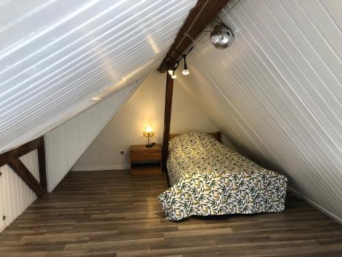 a bedroom with a bed in a attic at Villa ALOHA in Bray-Dunes