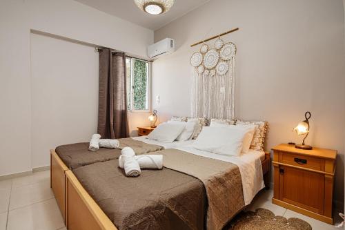 a bedroom with a large bed with white pillows at Aria Apartment in Zakynthos