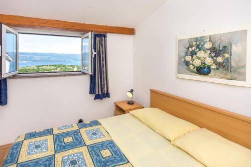 a bedroom with a bed and a window at Apartments House Risika in Risika