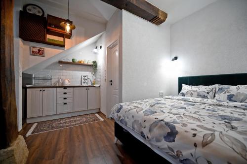 a bedroom with a bed and a kitchen in it at Apartments Magaza in Sarajevo