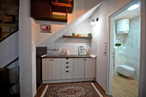 a bathroom with a sink and a stairway at Apartments Magaza in Sarajevo