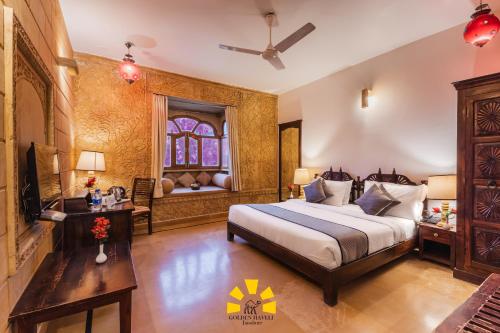 a bedroom with a large bed and a window at Hotel Golden Haveli in Jaisalmer