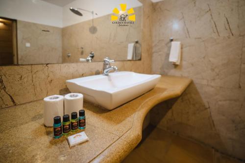 a bathroom with a sink and a counter with towels at Hotel Golden Haveli in Jaisalmer