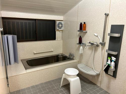 a small bathroom with a sink and a toilet at さきみや in Goto