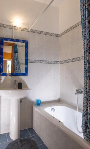 a bathroom with a bath tub and a sink at Natural Oasis Villa in Nea Fokea