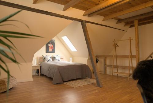 a bedroom with a bed in an attic at Akaciegaarden Bed & Breakfast in Hårlev