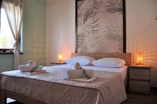 a bedroom with a large bed with towels on it at Jungle & Sea Boxavia in Božava