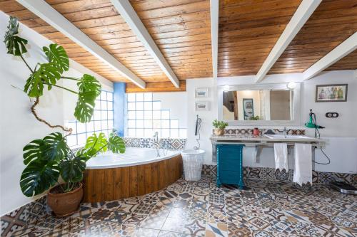 a bathroom with a tub and a sink at Finca el Albero in Carratraca